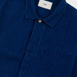 Blue shirt with a collar and pocket, featuring the brand 'Folk' on a white background.
