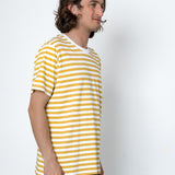 Man wearing a yellow and white striped shirt against a white background