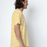 Person wearing a yellow and white striped shirt against a white background