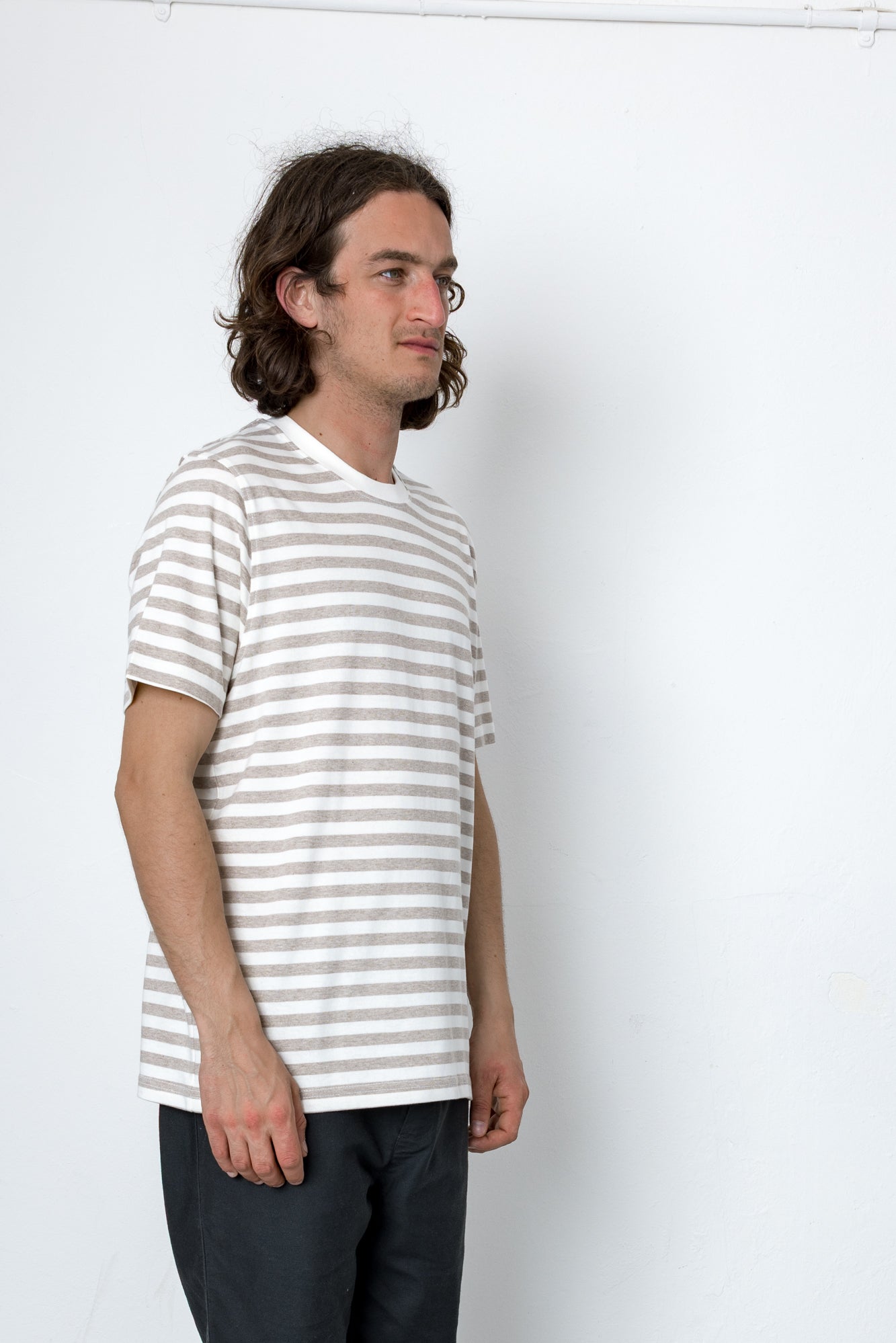 Man wearing a striped shirt against a white background