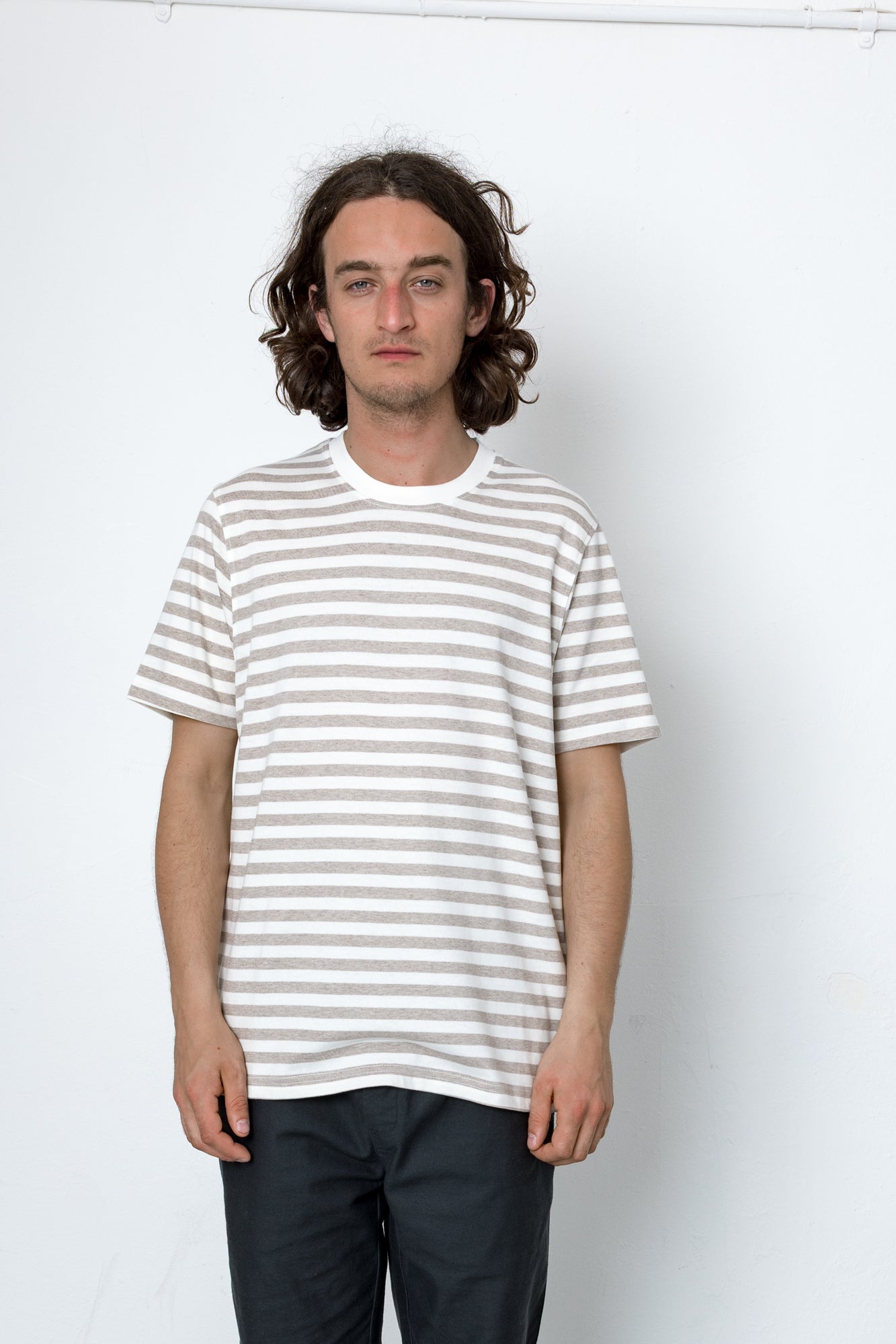 Man wearing a striped t-shirt against a white background