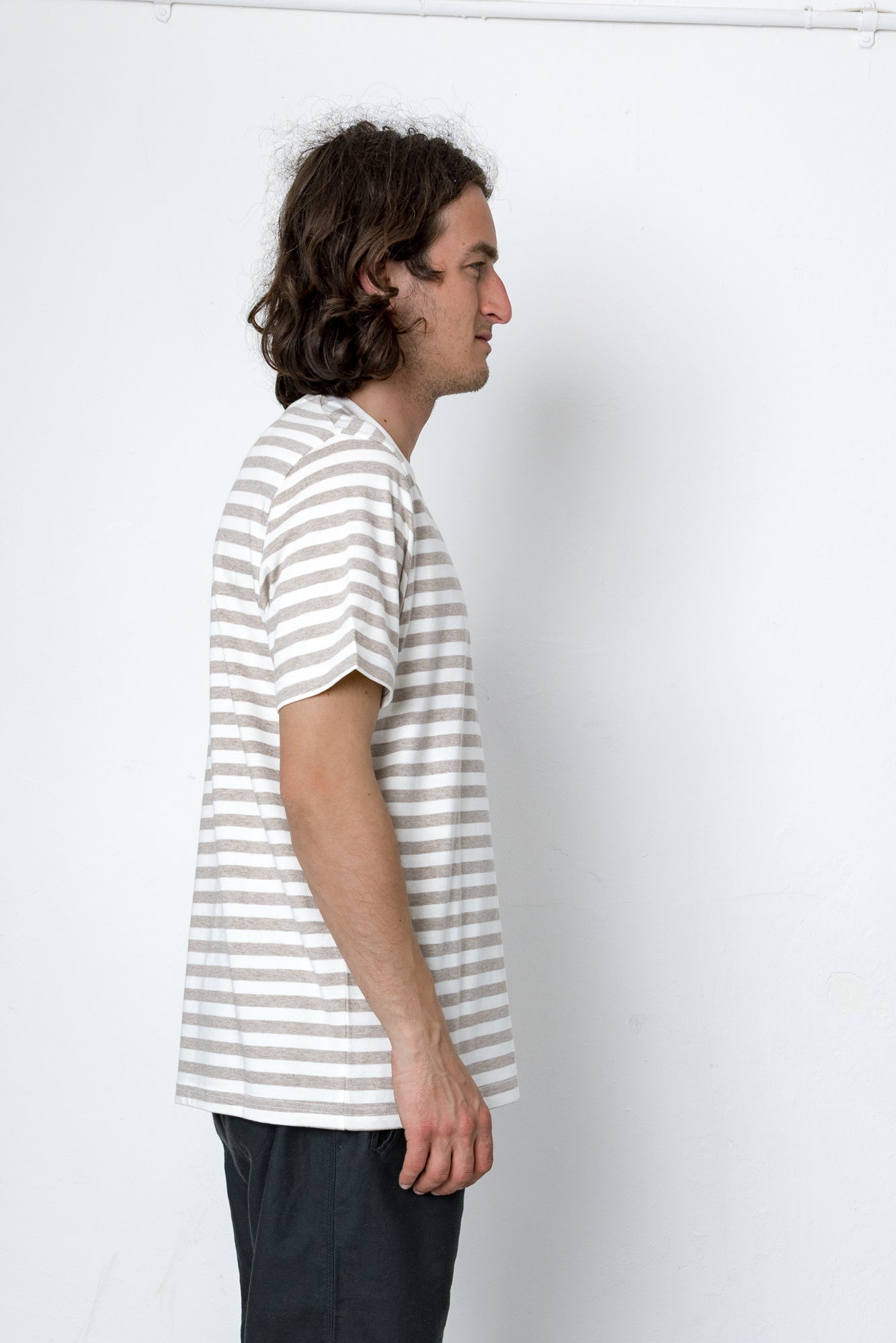 Person wearing a striped shirt against a white background