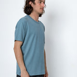 Man wearing a blue t-shirt against a white background