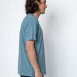 Man wearing a blue t-shirt against a white background