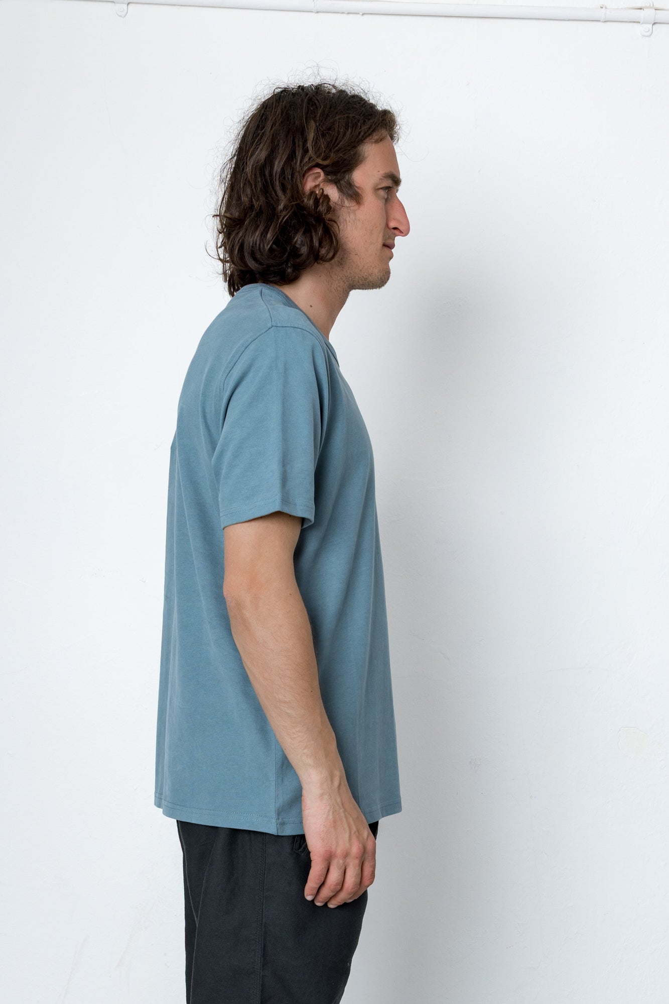 Man wearing a blue t-shirt against a white background