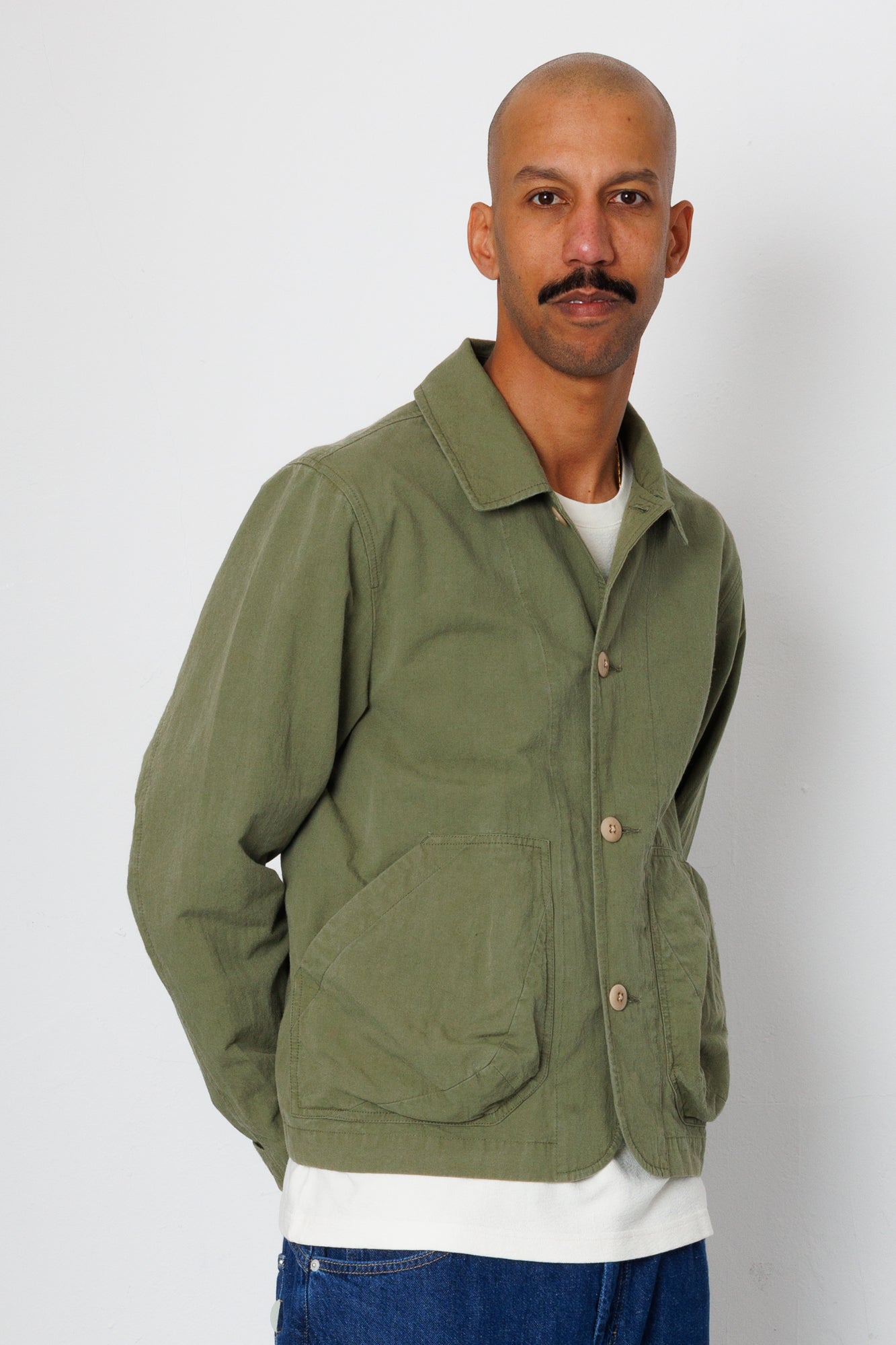 Man wearing a green jacket with a white background