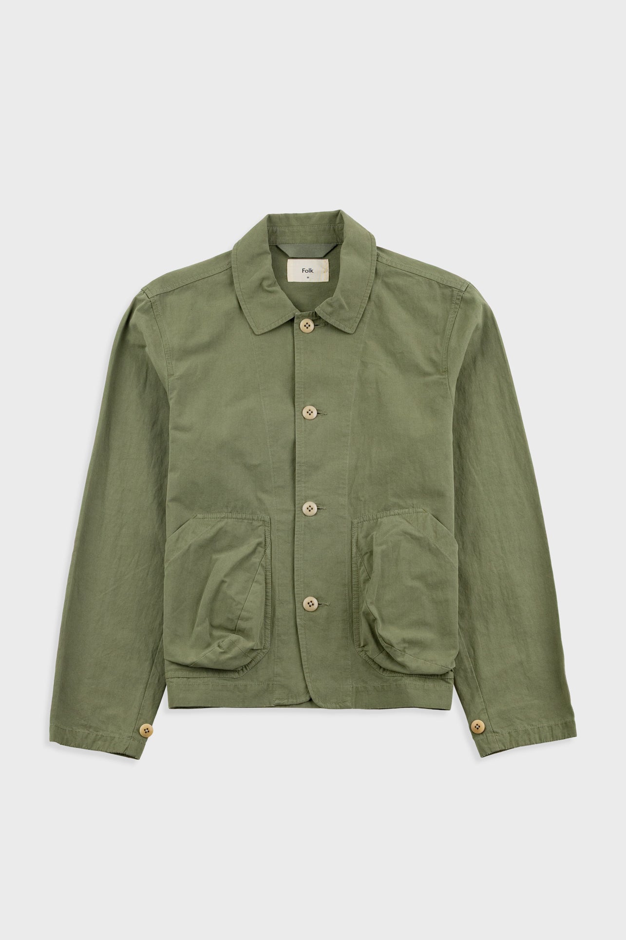 Green jacket with button details on a white background