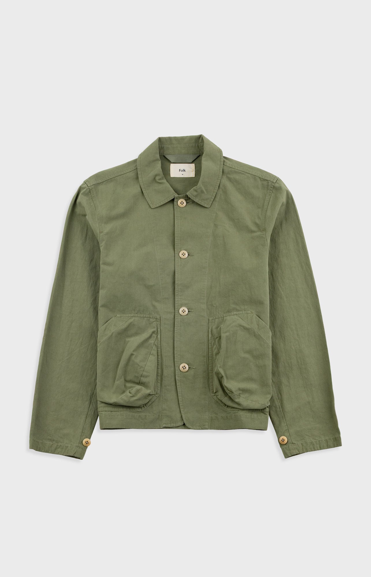 Green jacket with button details on a white background