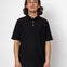 Man wearing a black polo shirt against a white background
