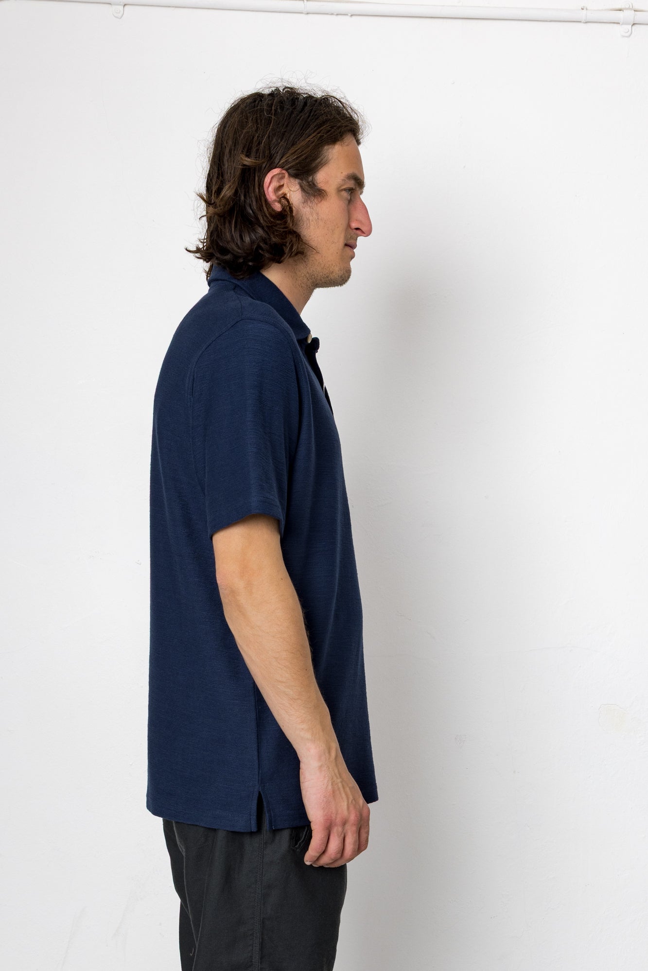 Man wearing a navy blue shirt against a white background