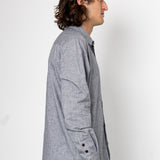 Man wearing a gray checkered shirt against a white background