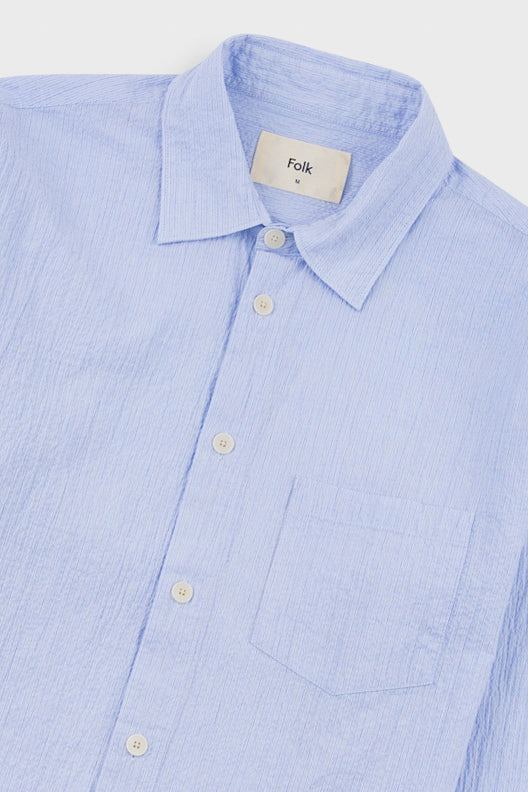 Light blue striped shirt with 'Folk' label on a white background