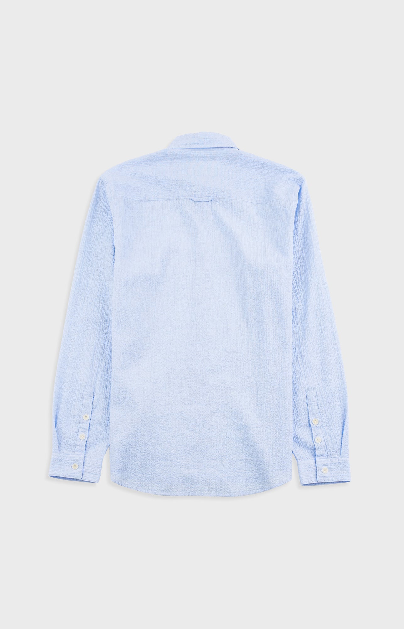 Light blue button-up shirt on a light gray background