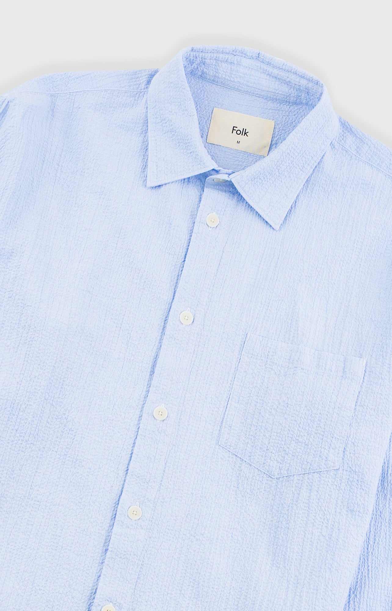 Light blue checkered shirt with 'Folk' label on a white background