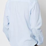 Light blue striped shirt worn by a person on a plain background