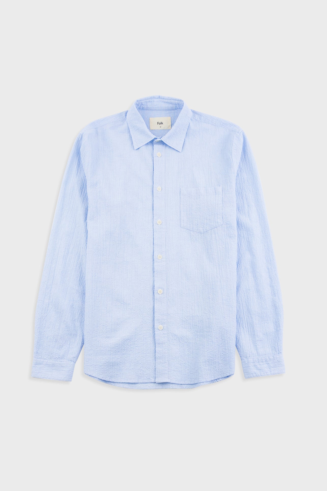 Light blue shirt on a light gray background