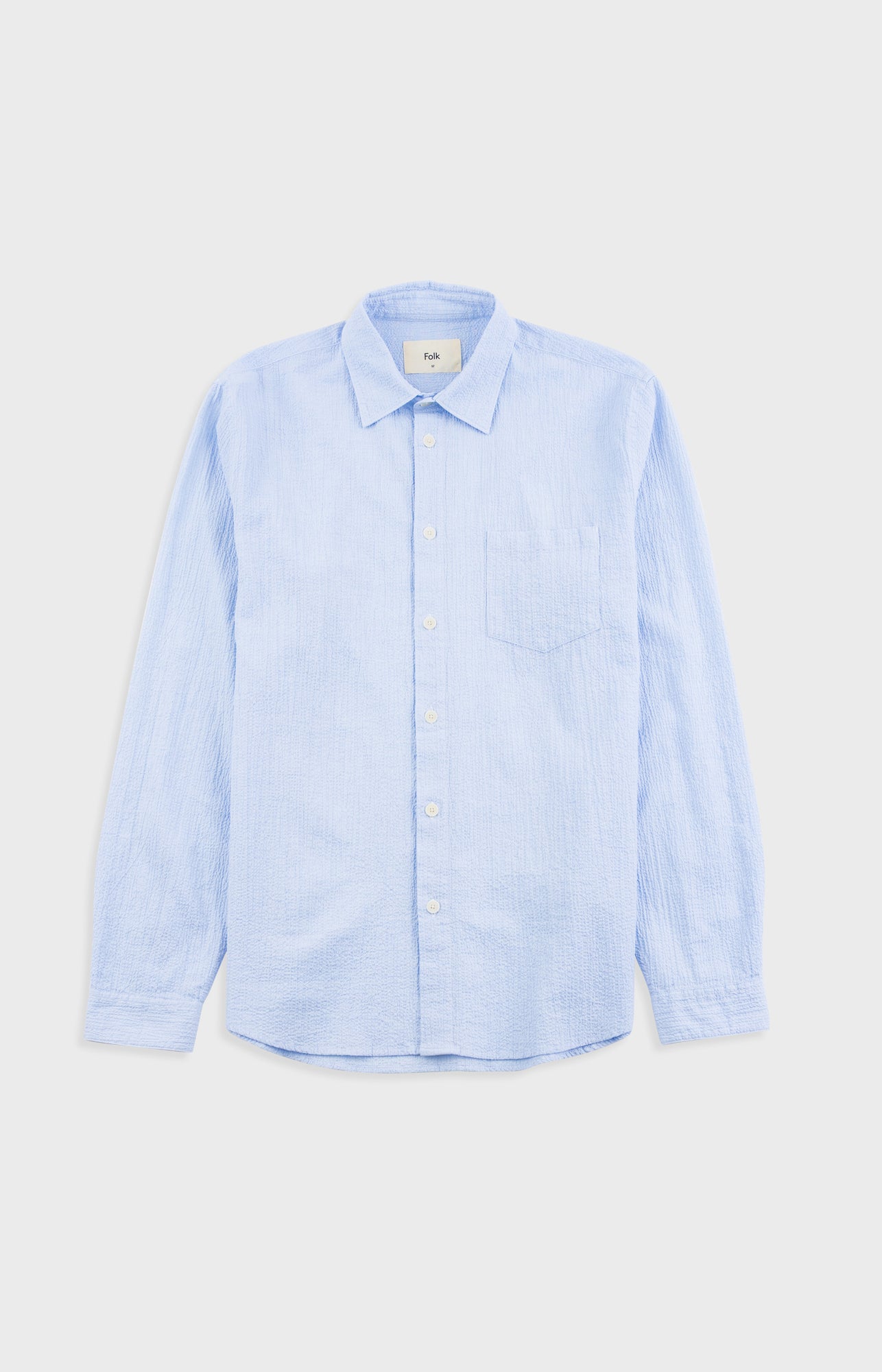Light blue shirt on a light gray background