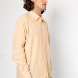 Man wearing a beige shirt against a white background