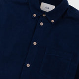 Navy blazer with a visible brand label on a light gray background
