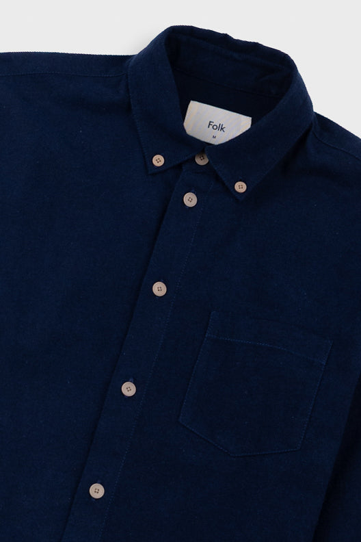 Navy blazer with a visible brand label on a light gray background