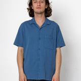 Man wearing a blue shirt against a white background