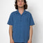Man wearing a blue shirt against a white background