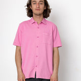 Person wearing a pink shirt against a white background