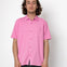 Person wearing a pink shirt against a white background