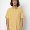 Man wearing a yellow shirt against a white background