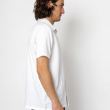 Man wearing a white shirt against a plain white background