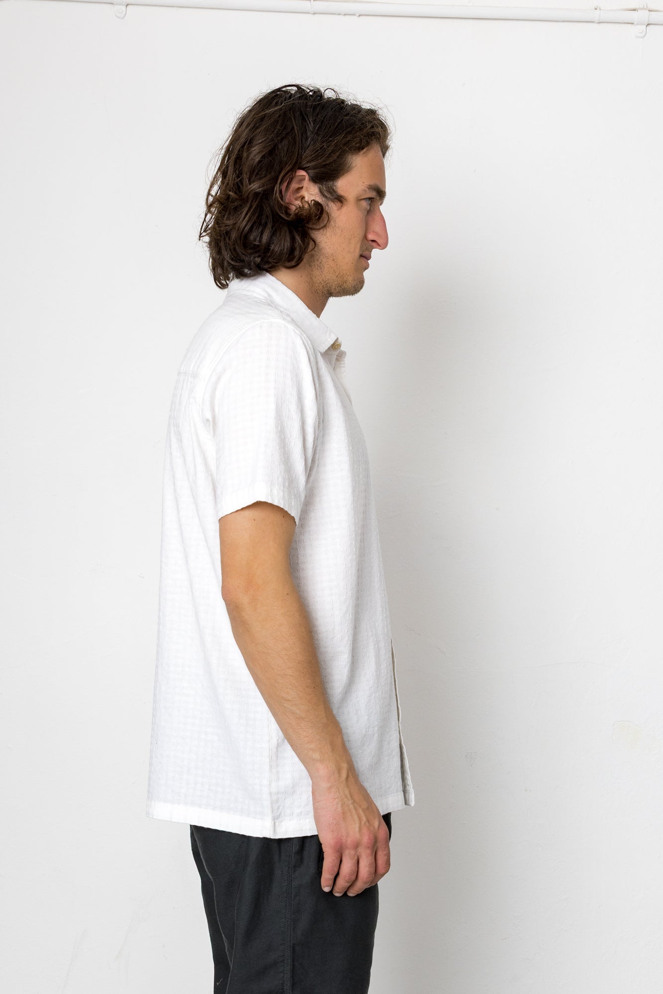 Man wearing a white shirt against a plain white background