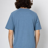 Person wearing a blue t-shirt against a white background