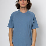 Person wearing a blue t-shirt against a white background