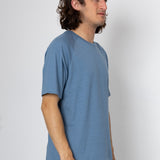 Man wearing a blue t-shirt against a white background