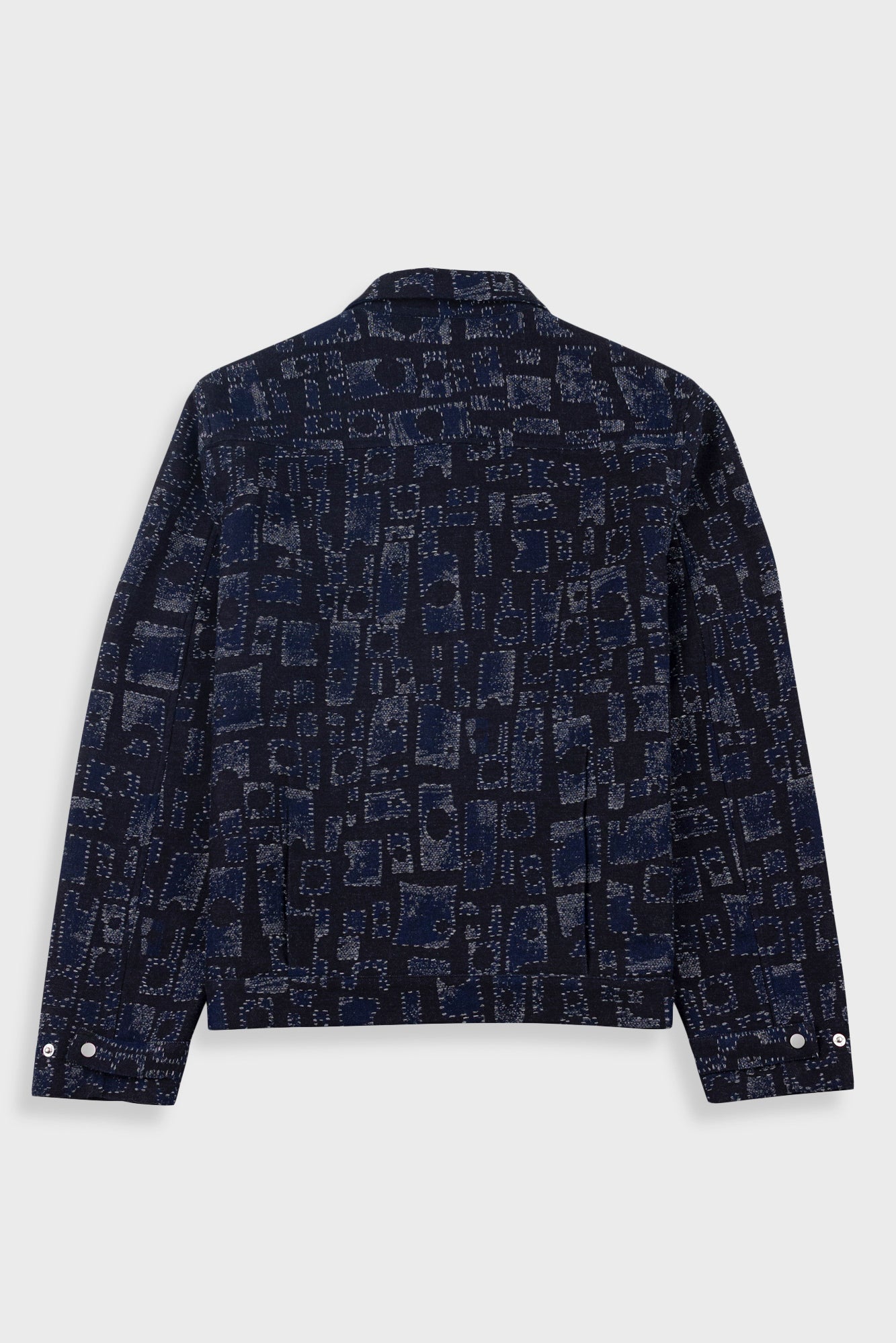 Dark blue patterned jacket on a light gray background