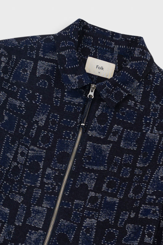 Navy patterned jacket with a visible brand label on a white background