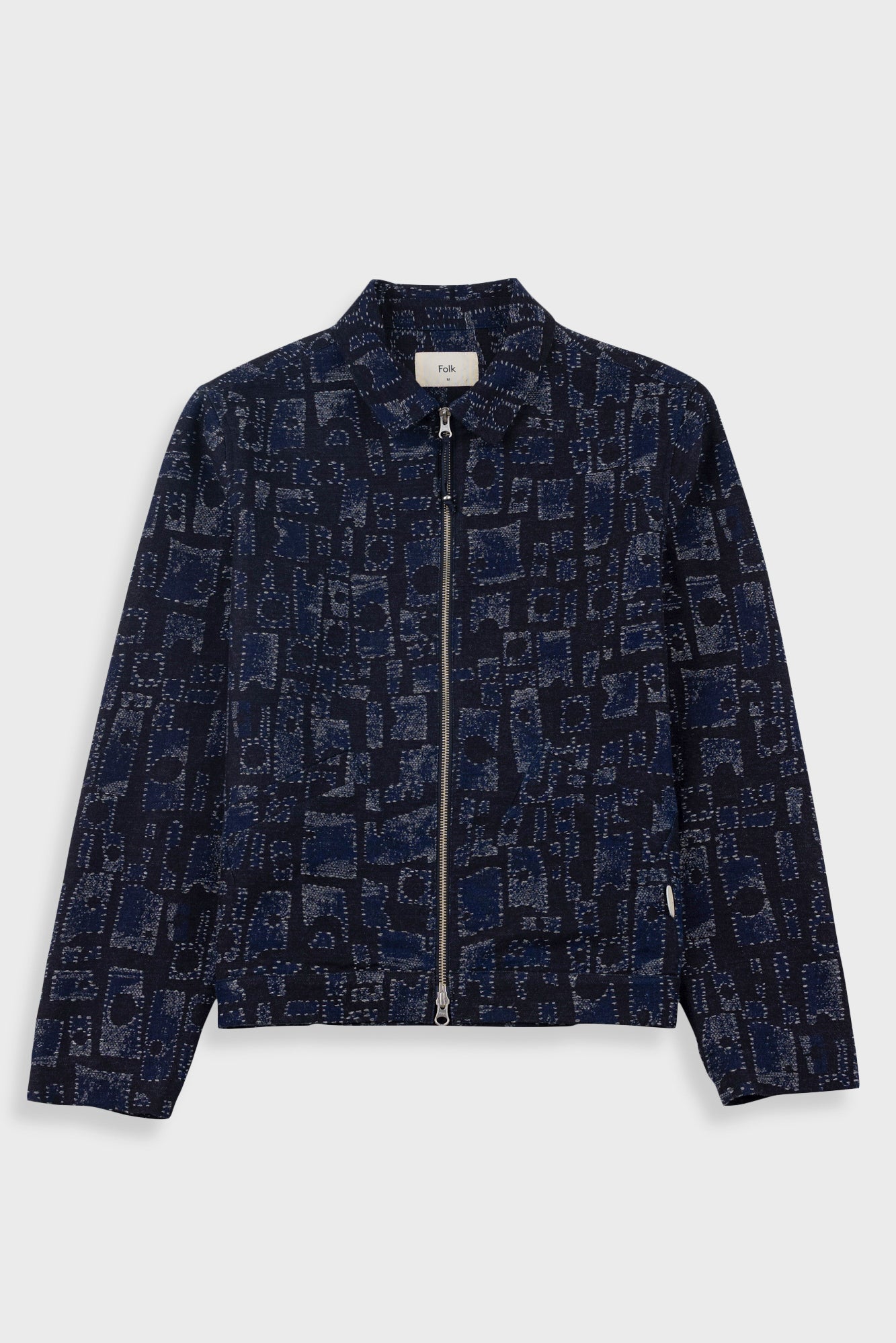 Dark blue patterned jacket on a light gray background