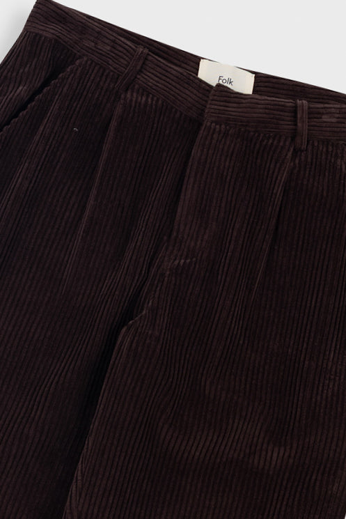 Brown corduroy pants with a visible brand label on a white background