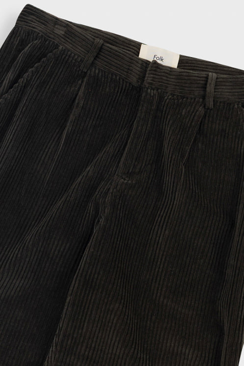 Dark brown corduroy pants on a light gray background