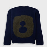 Navy blue sweater with a large brownish-green abstract design on a white background