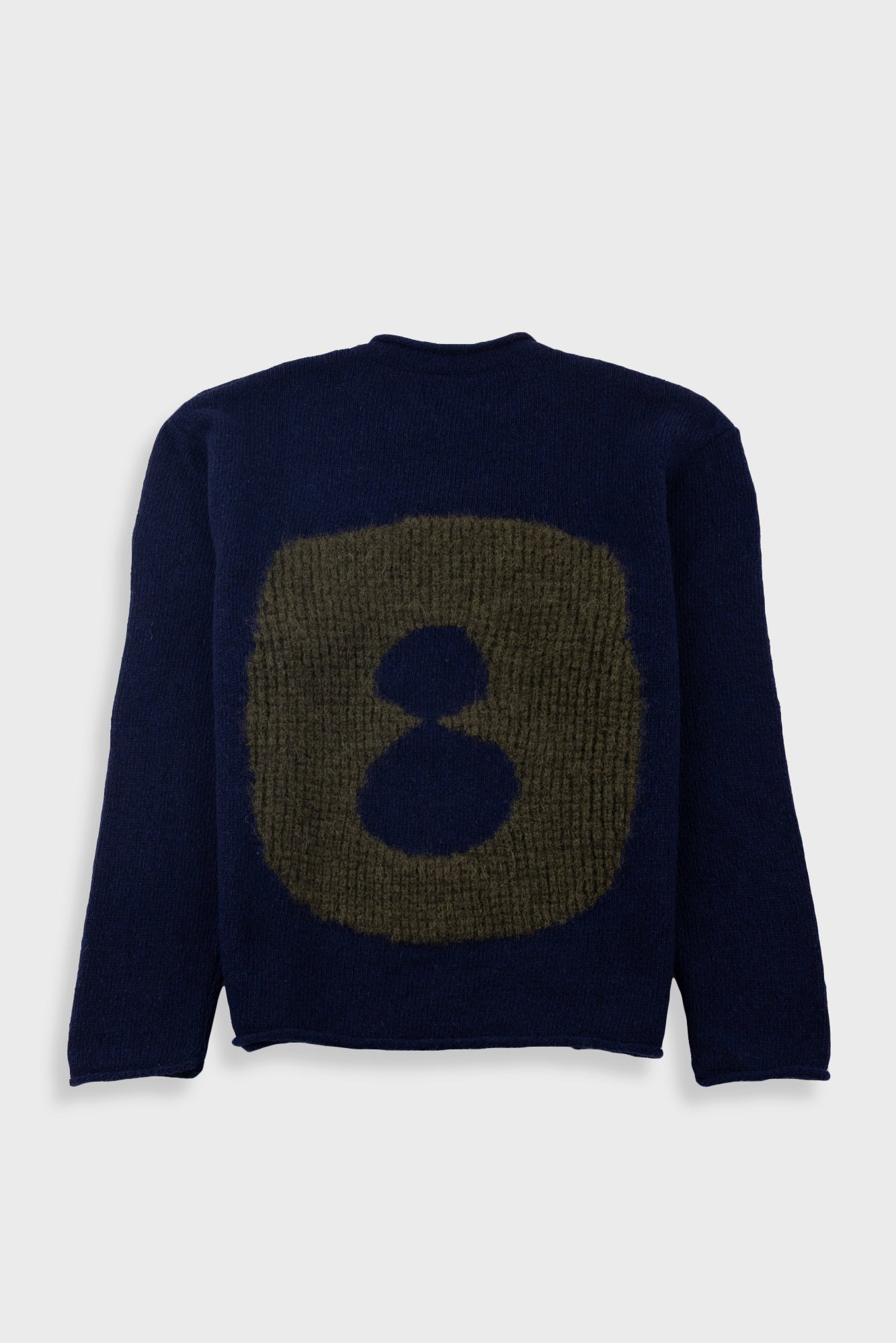 Navy blue sweater with a large brownish-green abstract design on a white background