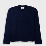 Navy blue sweater with a visible brand label on a white background