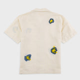 Beige t-shirt with colorful graphic designs on a white background