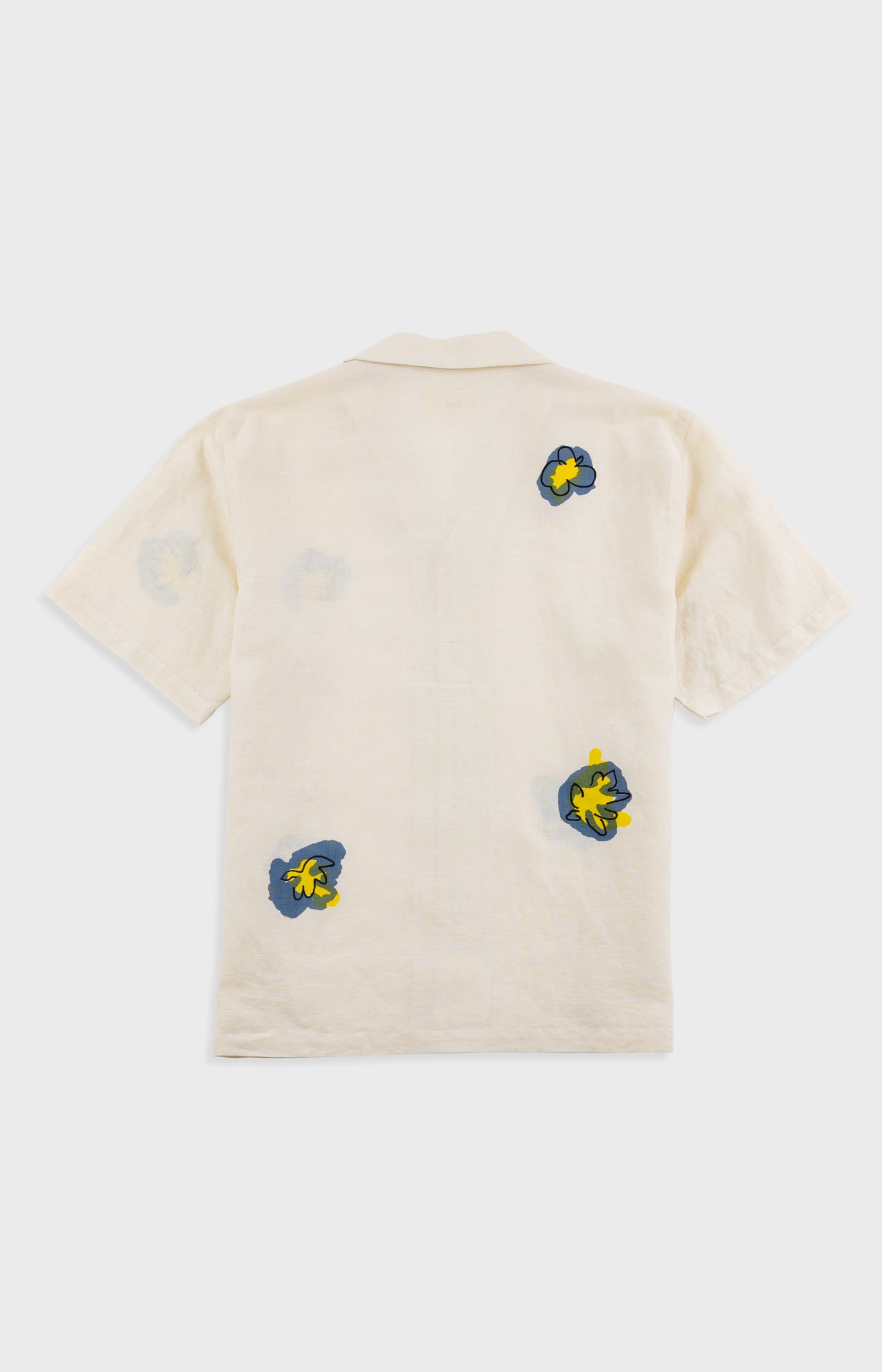 Beige t-shirt with colorful graphic designs on a white background