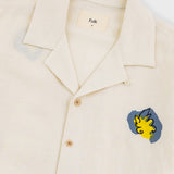 Beige shirt with colorful patches on a white background
