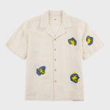 Beige shirt with embroidered designs on a white background