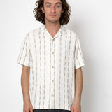Man wearing a white striped shirt against a plain background