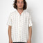 Man wearing a white striped shirt against a plain background