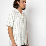 Man wearing a white striped shirt against a white background
