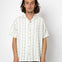 Man wearing a white striped shirt against a white background